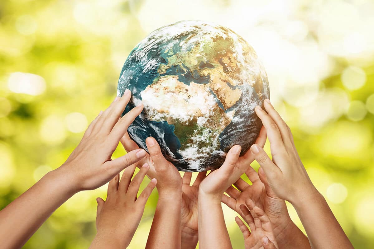 hands lifting a globe to signify sustainability