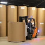 Fork Lift with rolls of kraft paper to make fibre drums min