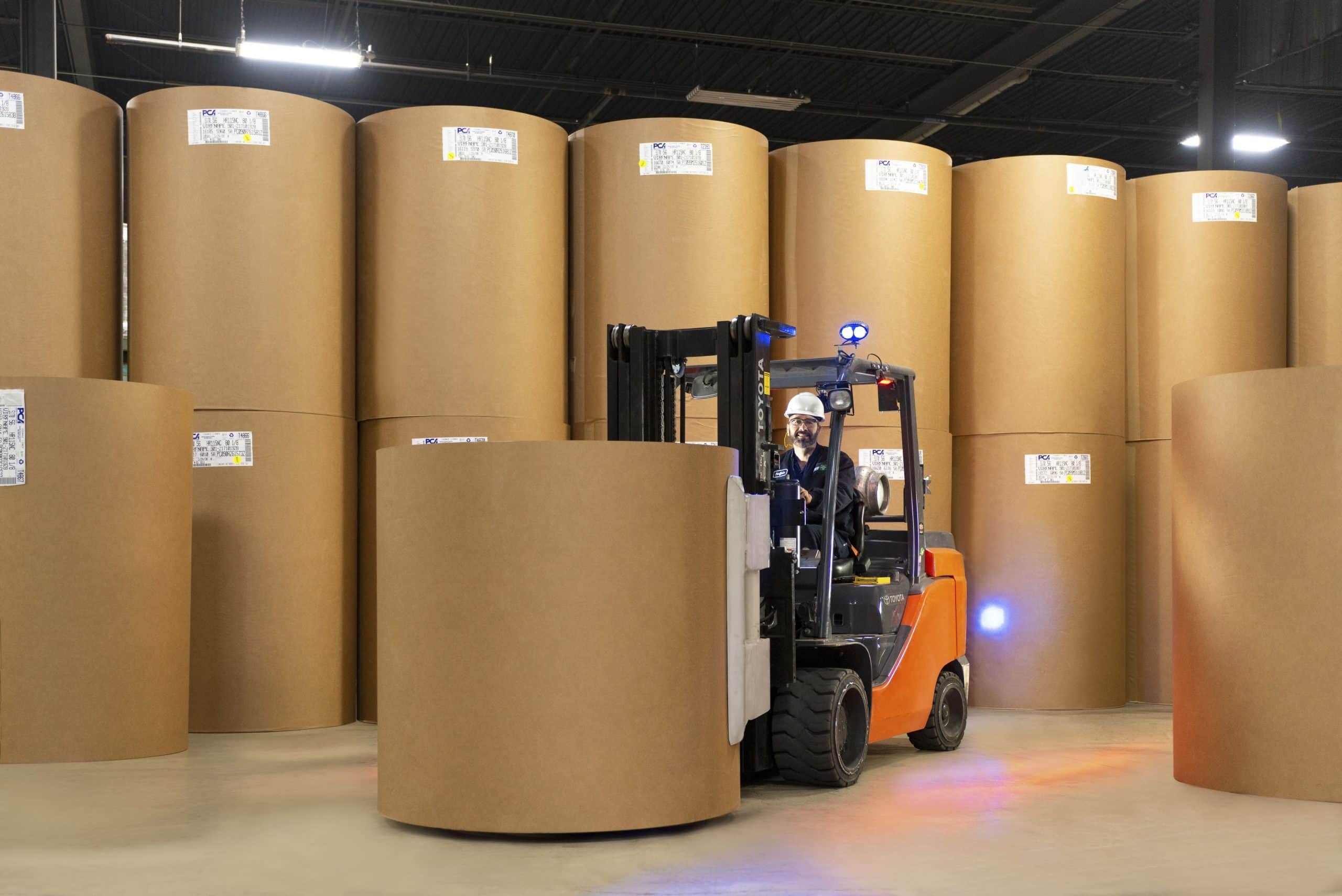 Fork Lift with rolls of kraft paper to make fibre drums min