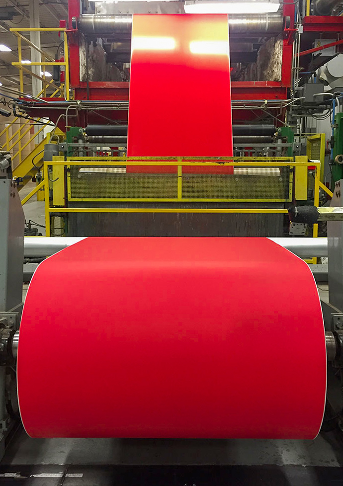 A bright red coating from Greif being applied to roll stock paper