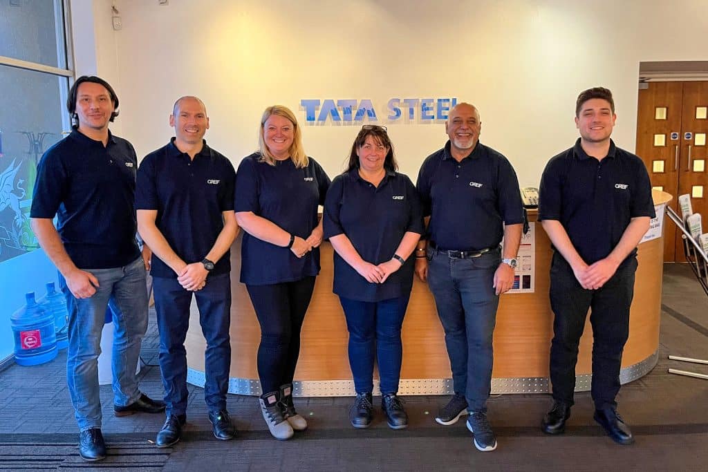 Greif team standing at the entrance to Tata Steel