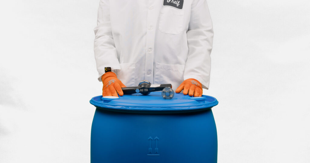 A Greif colleague stands behind a product to show how to close it