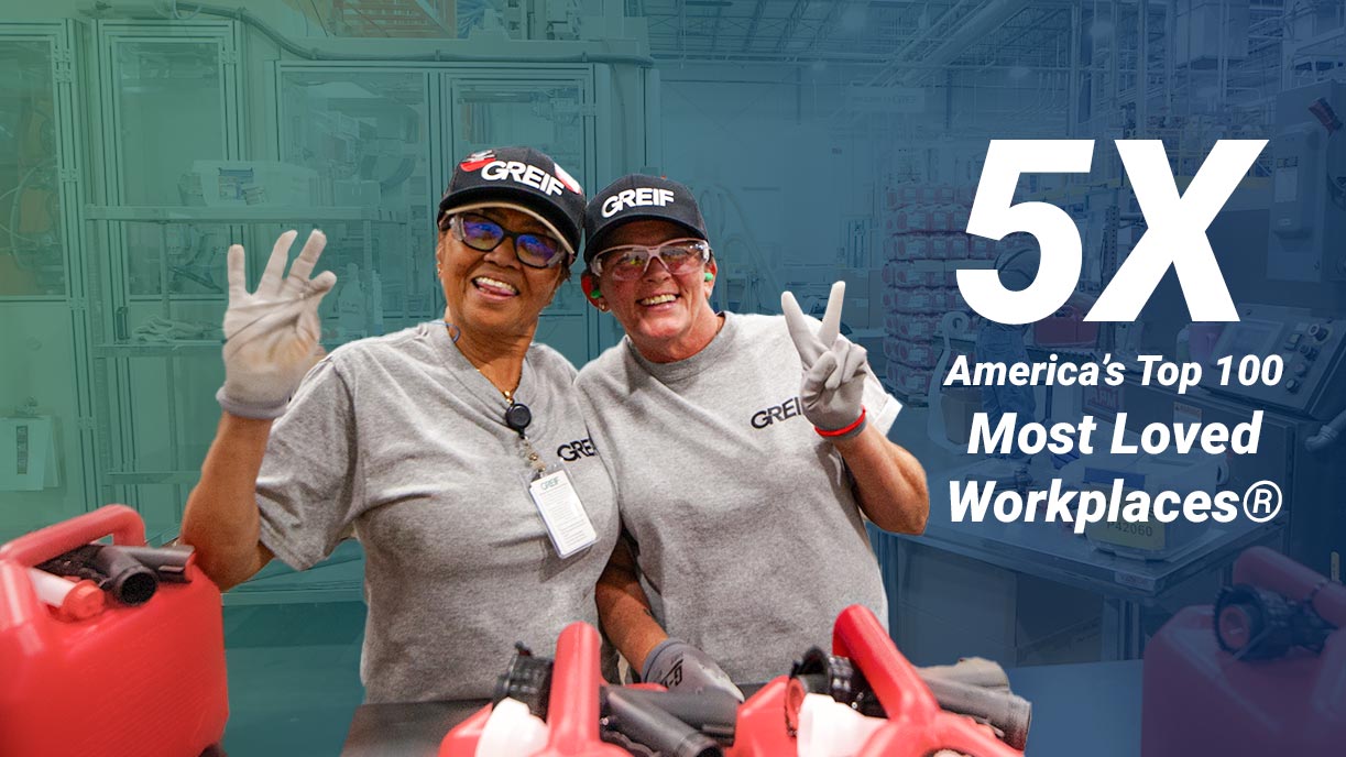 Two Greif colleagues smile and salute the camera